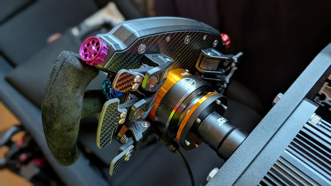 Close-up of Pokornyi wheel showing Porsche branding and rotary controls
