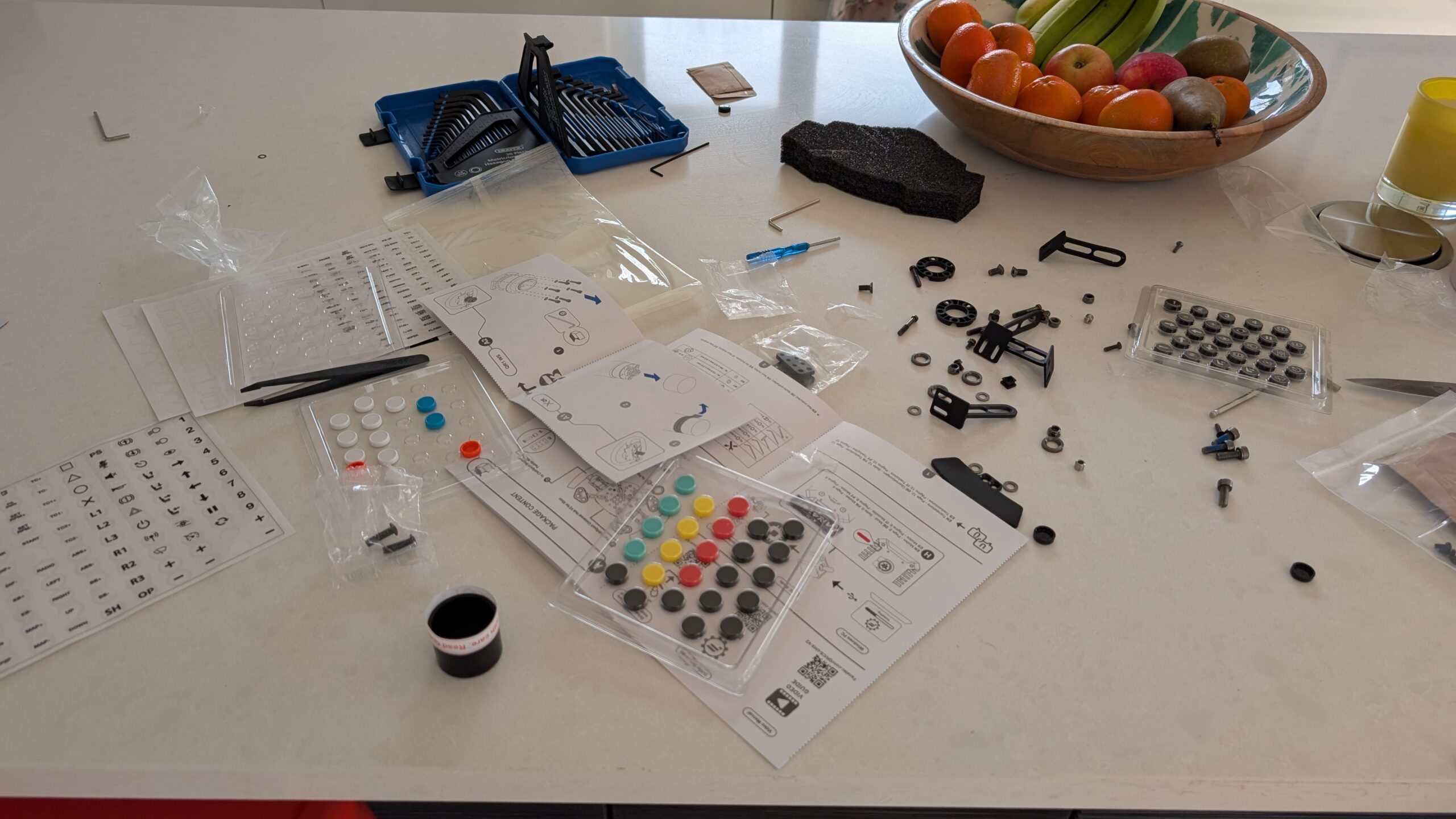 Button caps, sticker sheets, tools and screws laid out for the ClubSport GT3 wheel build