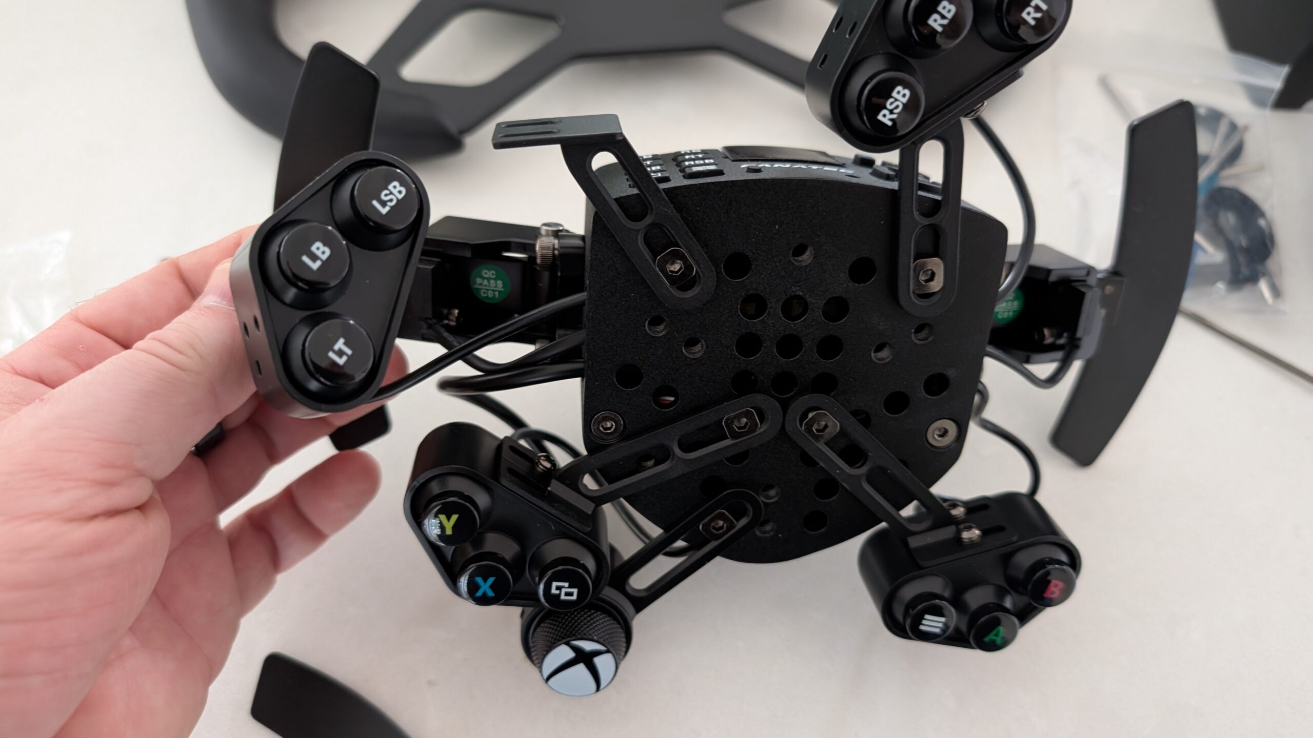 Close-up of the ClubSport Universal Hub V2 for Xbox showing carbon fibre front plate and button layout