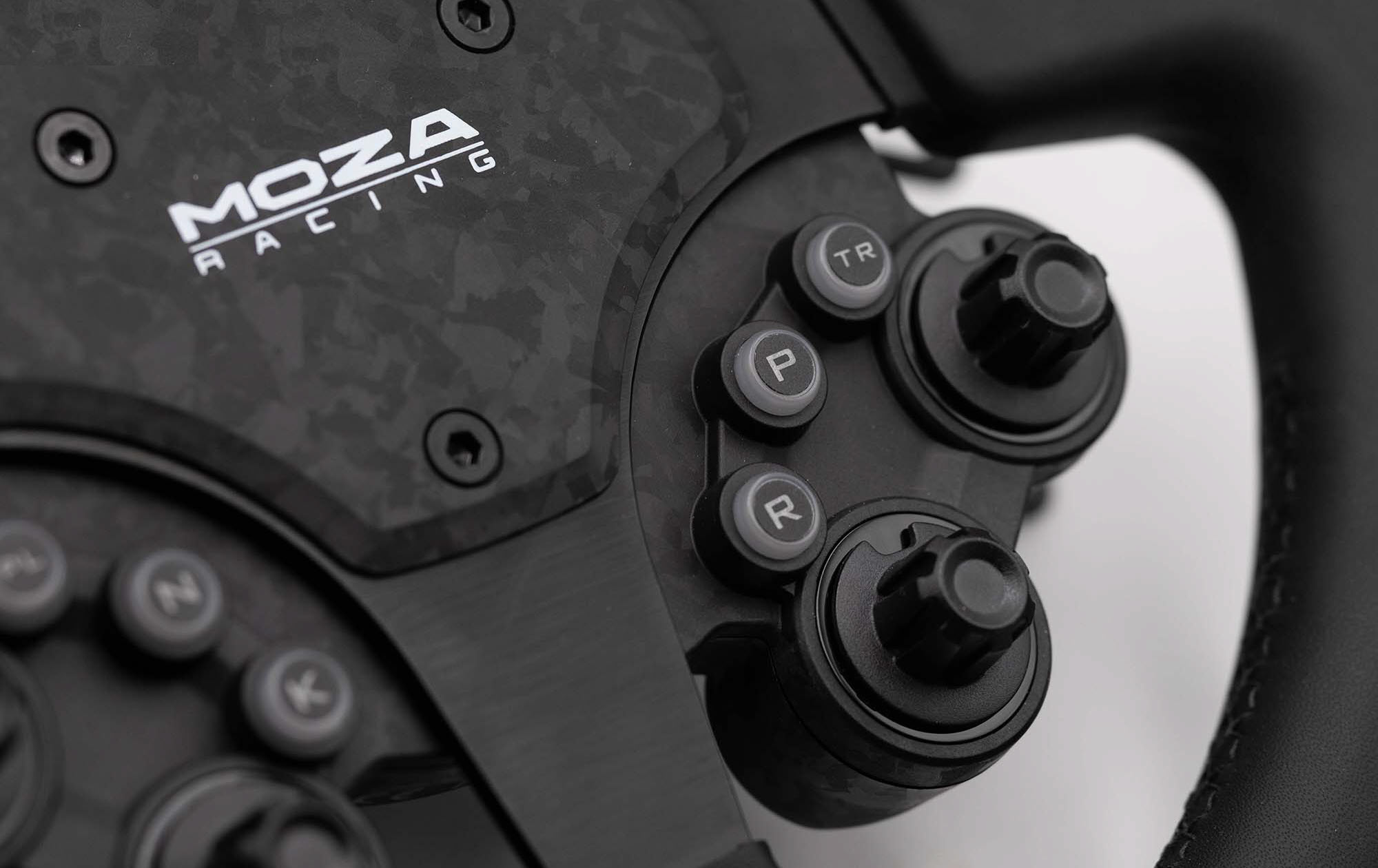 MOZA CS Pro close-up of backlit rotary encoders and buttons with forged carbon detail