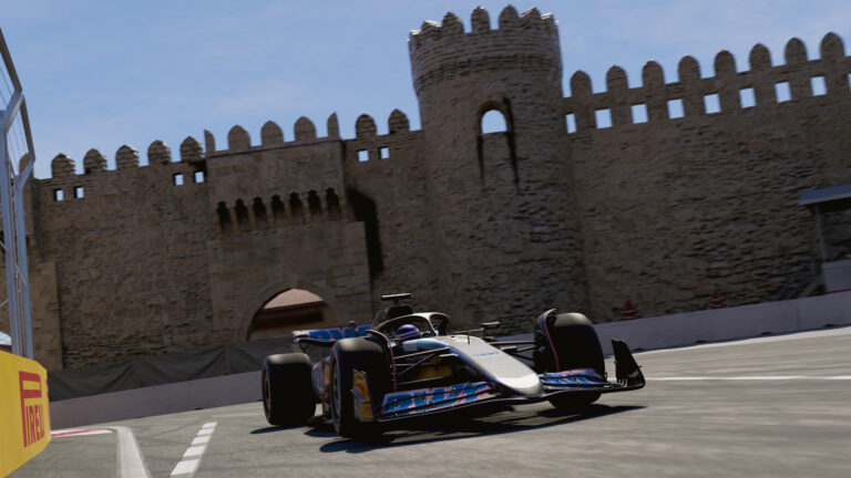Formula 1 car cornering at the Baku City Circuit with the historic Maiden Tower / city walls visible behind