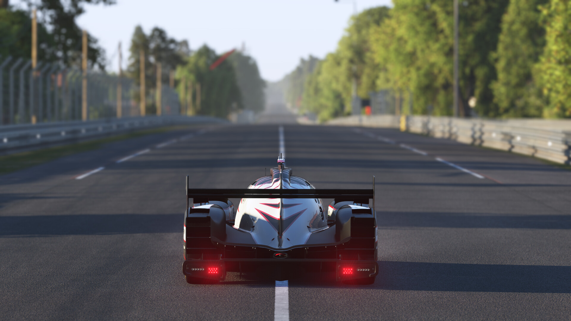 A lone Le Mans Ultimate Hypercar running down the empty Mulsanne straight