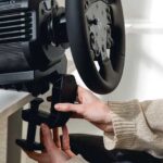 Logitech RS50 mounted on a desk via the included steel table clamp