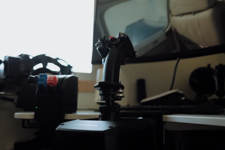 MOZA MH16 flight stick mounted on AB9 FFB base in foreground silhouette, secondary throttle quadrant in soft focus left, window light behind - atmospheric home flight sim setup