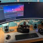 Pimax Crystal Light VR headset on Richard Baxter's wooden desk at SRC HQ - curved monitor, speakers, mechanical keyboard, SteamVR open