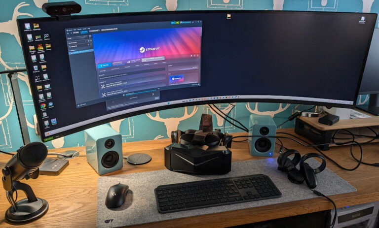 Pimax Crystal Light VR headset on Richard Baxter's wooden desk at SRC HQ - curved monitor, speakers, mechanical keyboard, SteamVR open