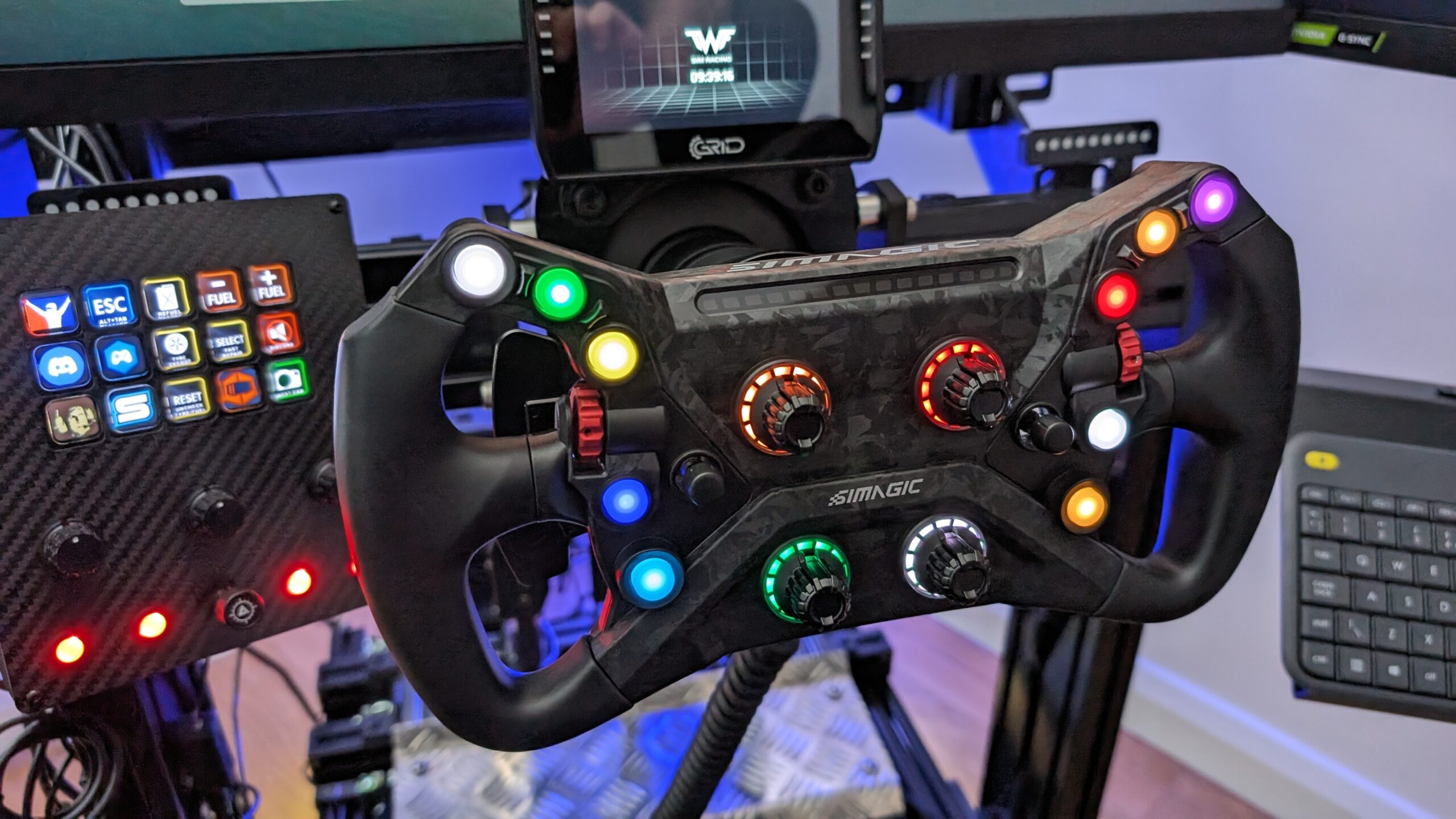 Simagic GT NEO formula wheel mounted and lit up on the sim rig