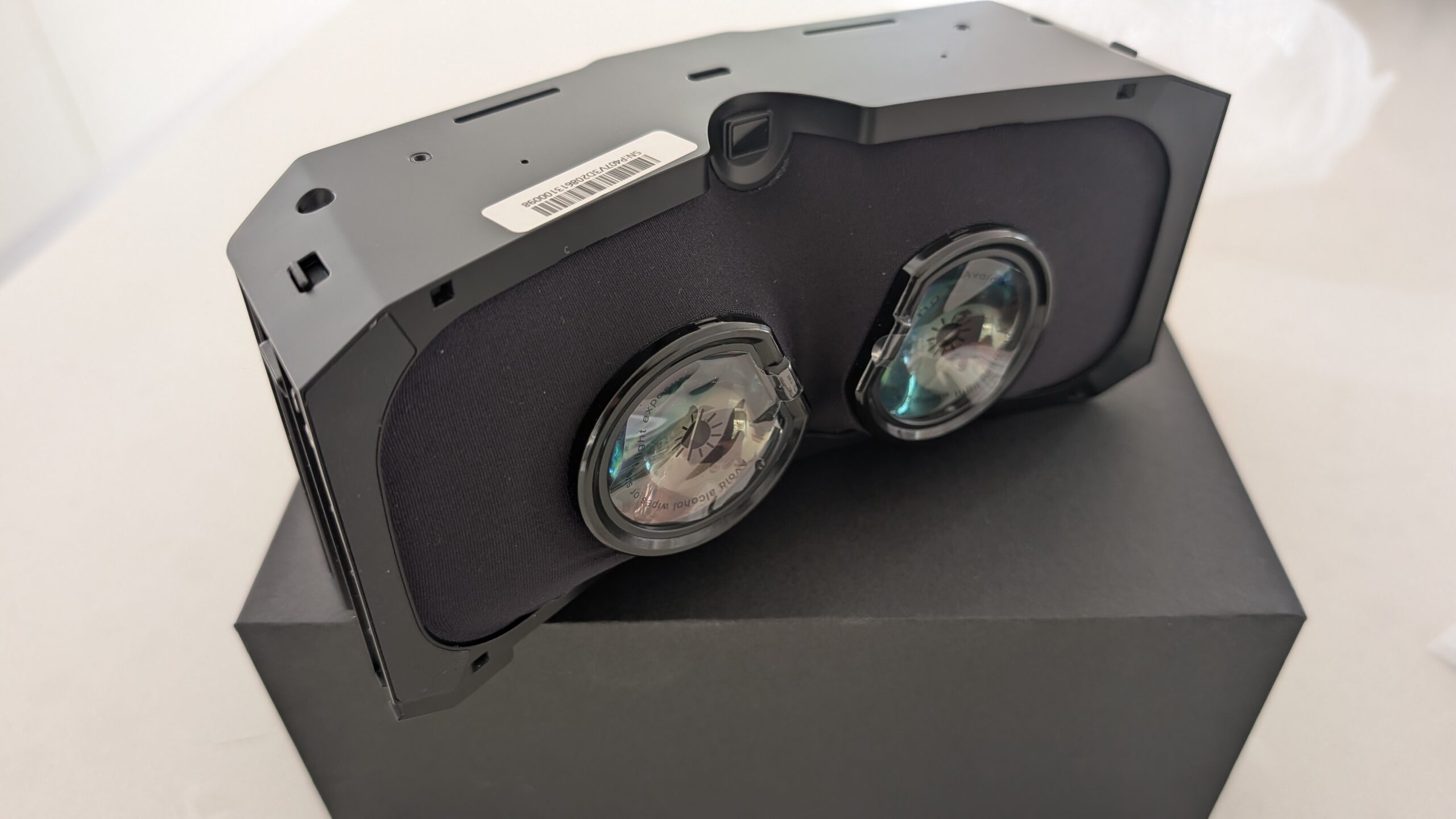 Angled view of the Pimax micro-OLED optical engine showing the lens assembly and housing