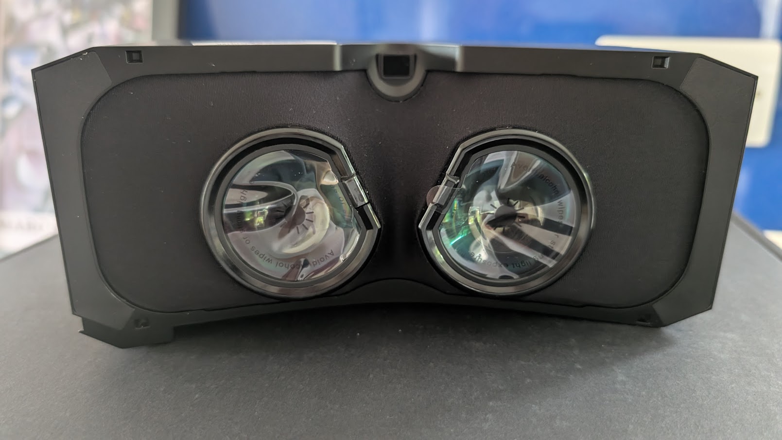 Pimax Crystal Super micro-OLED optical engine on a desk, pancake lenses with protective film still fitted
