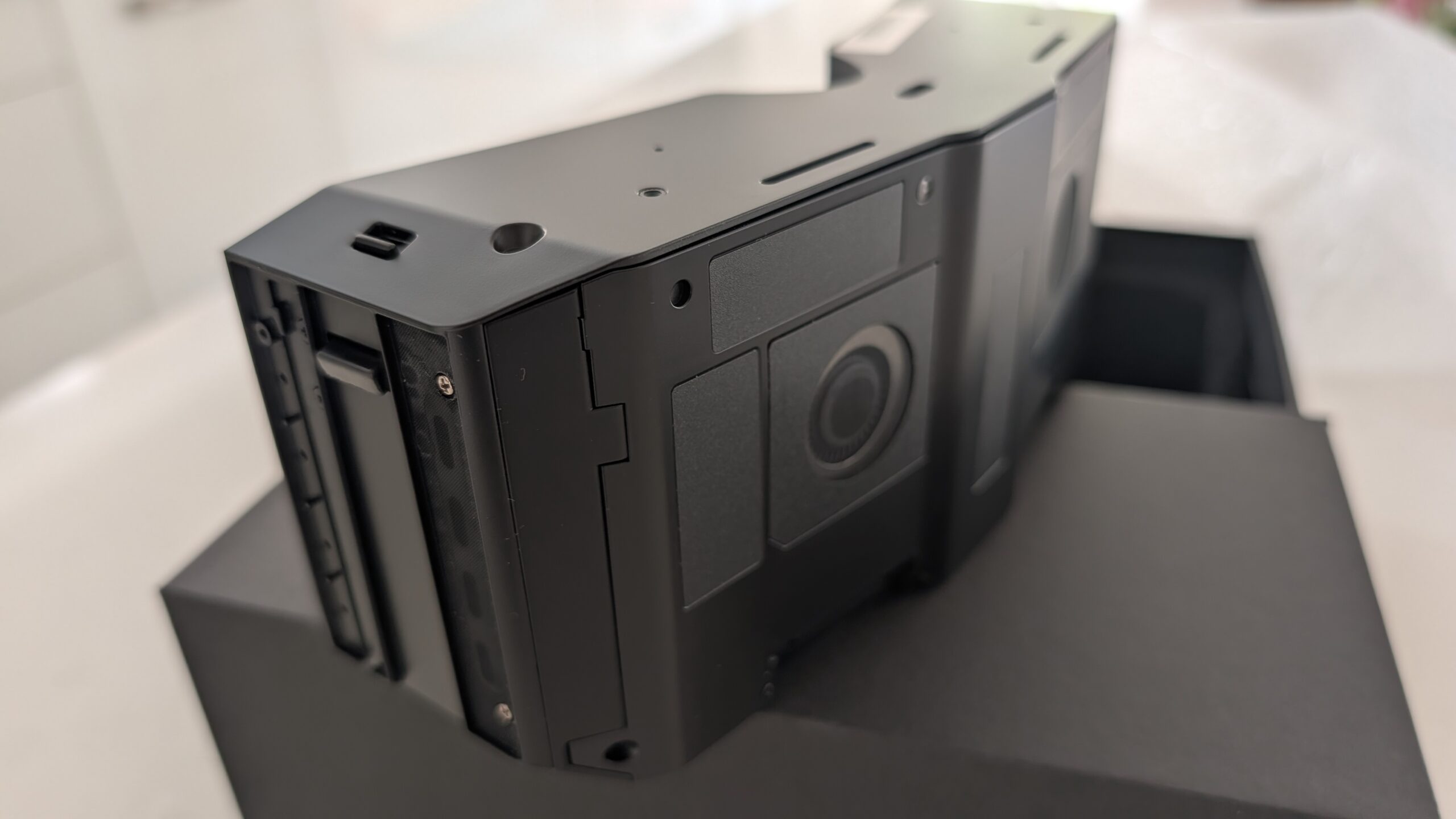 Side quarter view of the Pimax Crystal Super micro-OLED optical engine showing the mounting rails