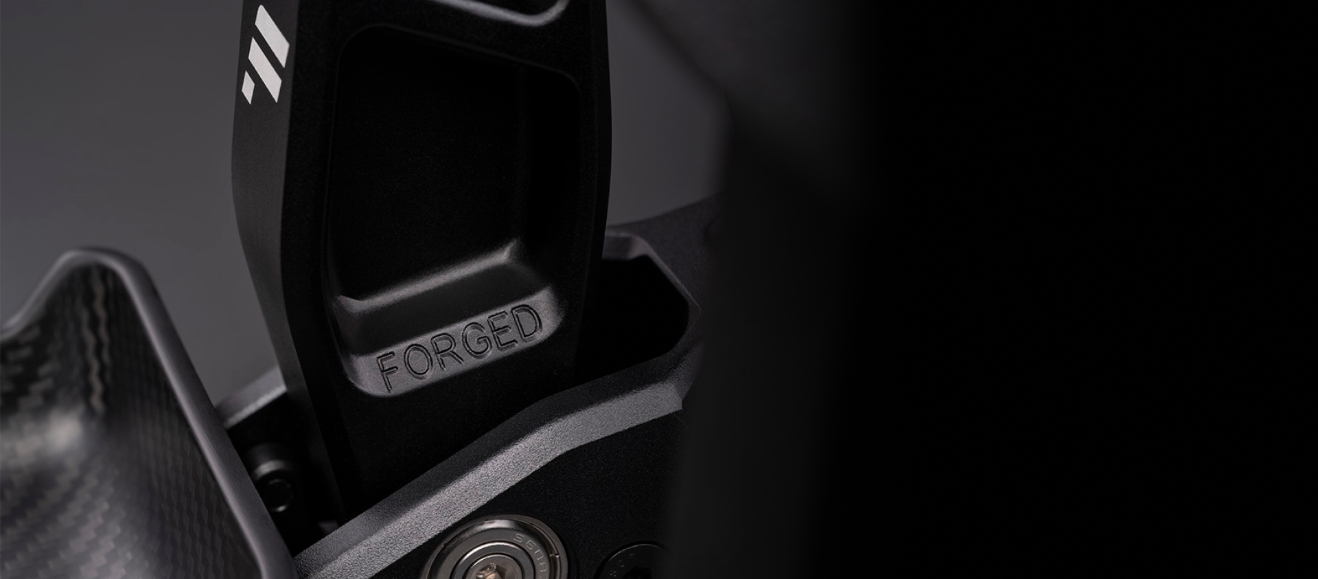 Detail of the forged aluminium brake arm on the Fanatec Podium Pedals, stamped FORGED