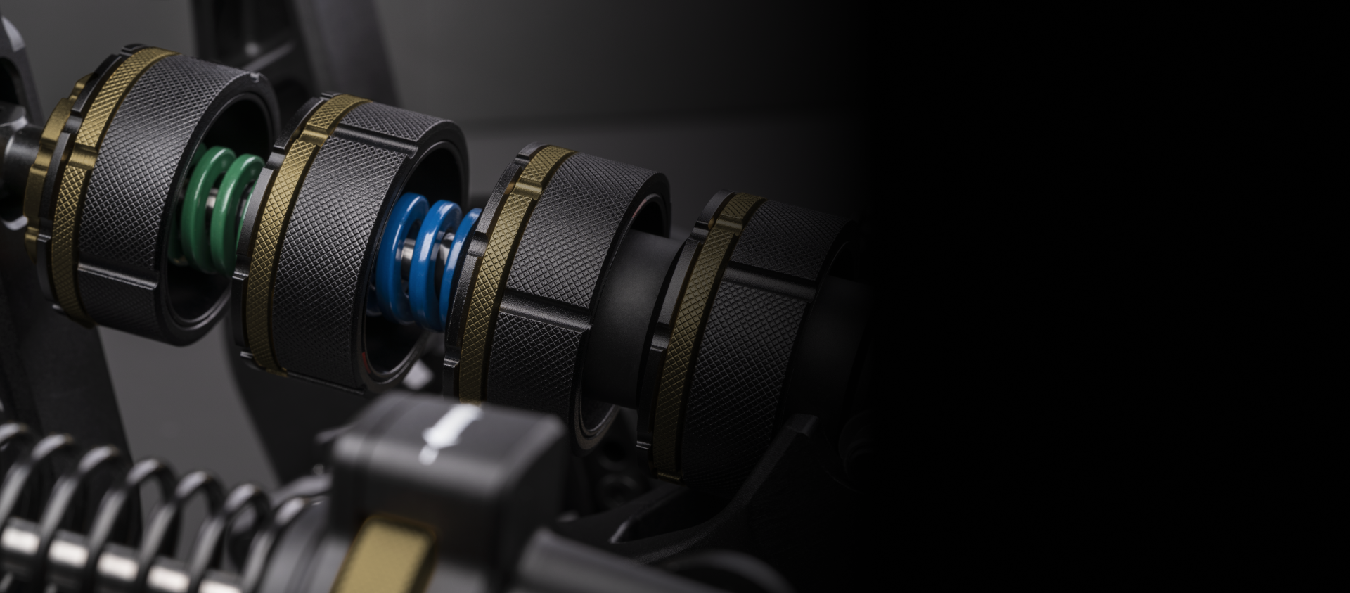 Close-up of the green and blue tuning springs inside the Fanatec Podium Pedals Compression Control System