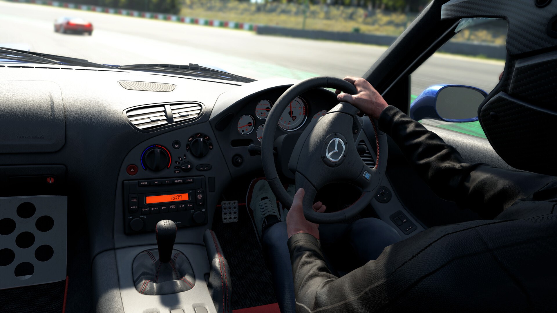 Cockpit view of a Mazda RX-7 in Assetto Corsa EVO, driver hands on the steering wheel