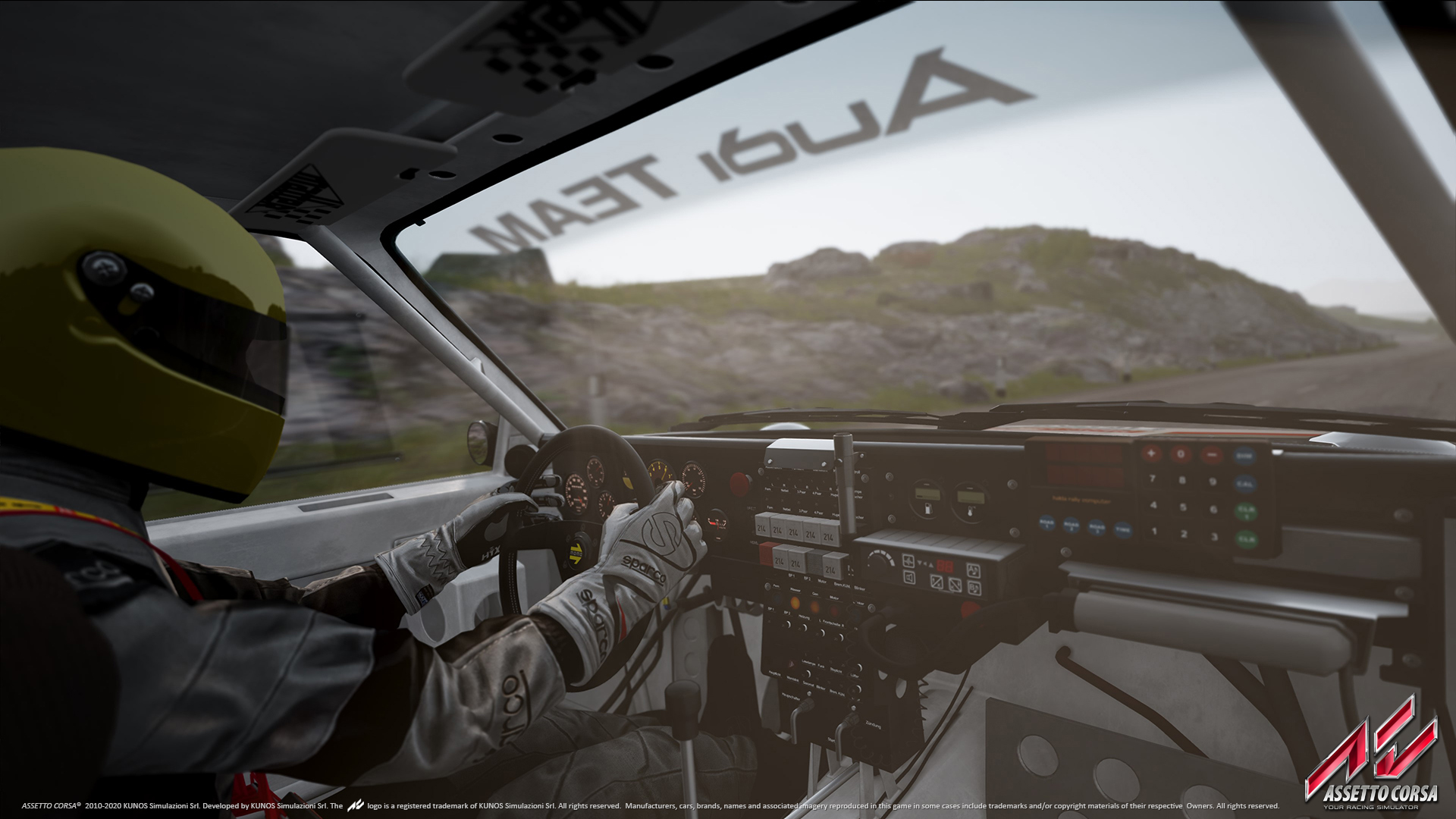 Driver's hands on the wheel of the Audi Sport quattro rally car in Assetto Corsa