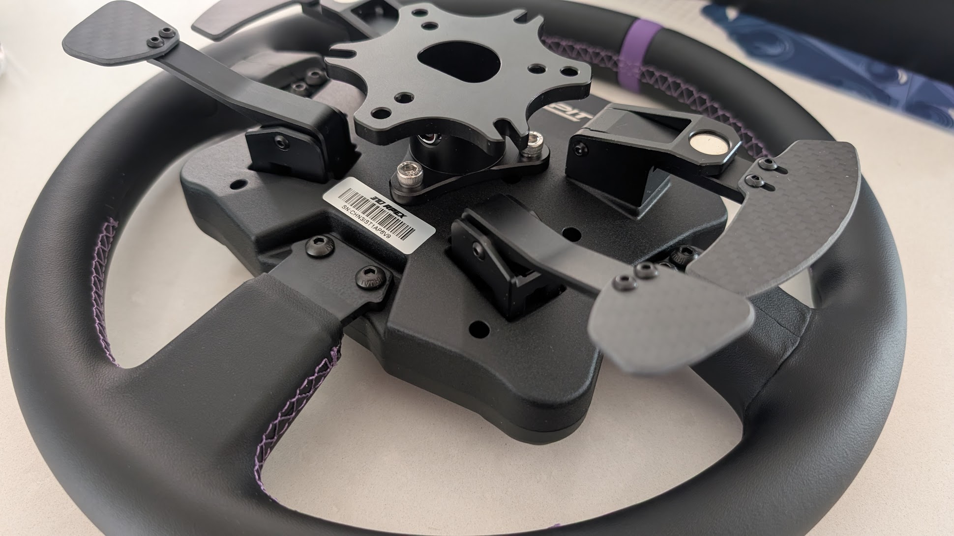 Rear of the Conspit 310 APEX showing the carbon shift paddles, the clutch paddles and the adapter plate