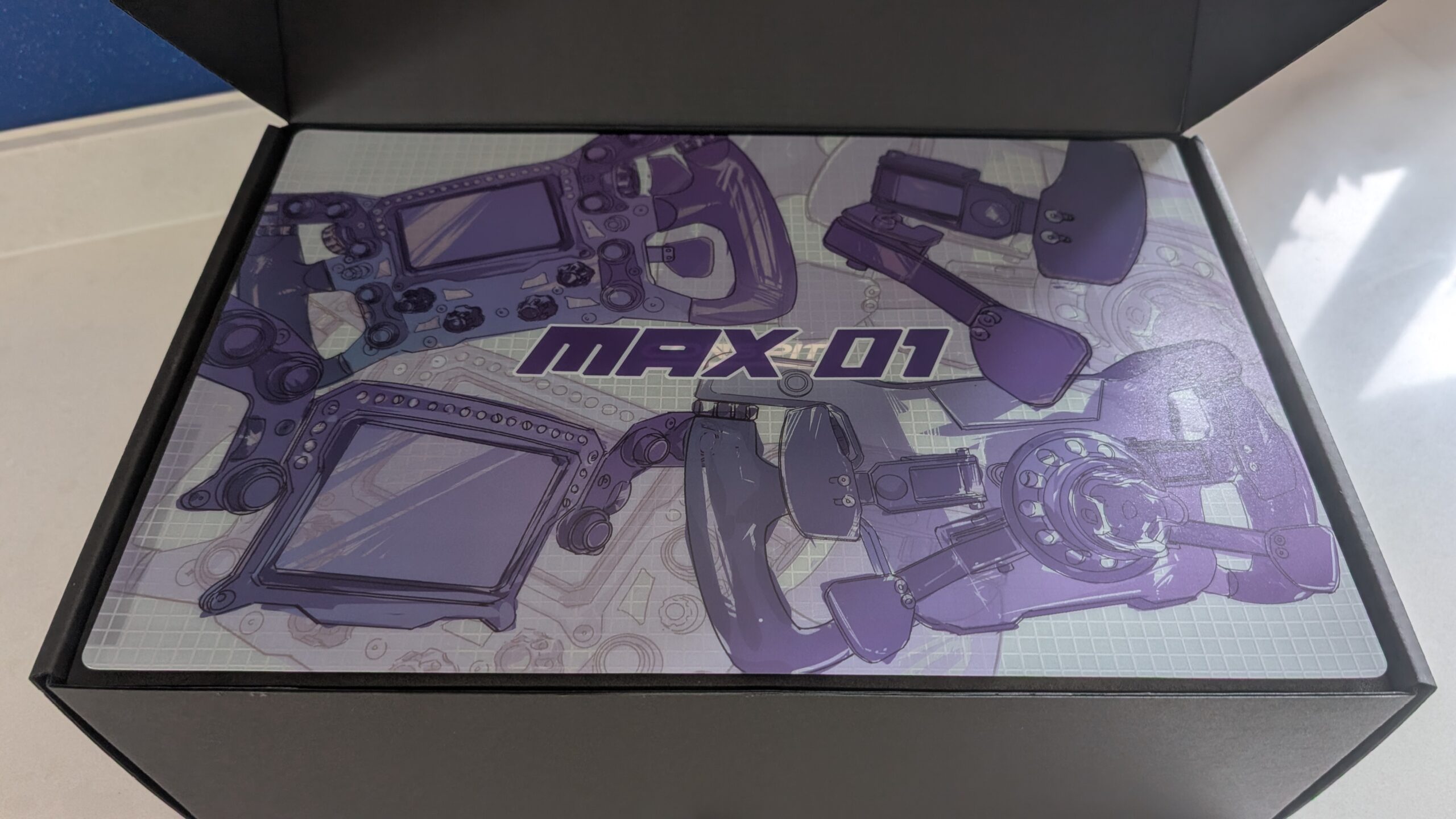 Conspit Max 01 retail box open, showing the printed foam insert