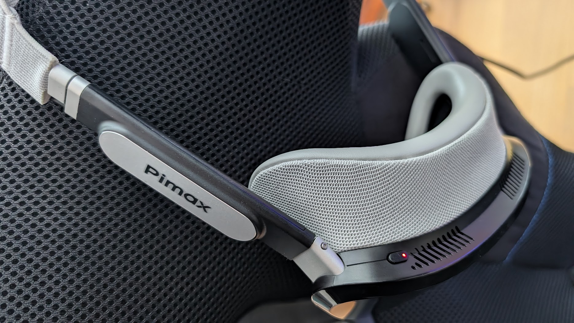 Pimax Dream Air powered up on a sim racing seat with the status light lit