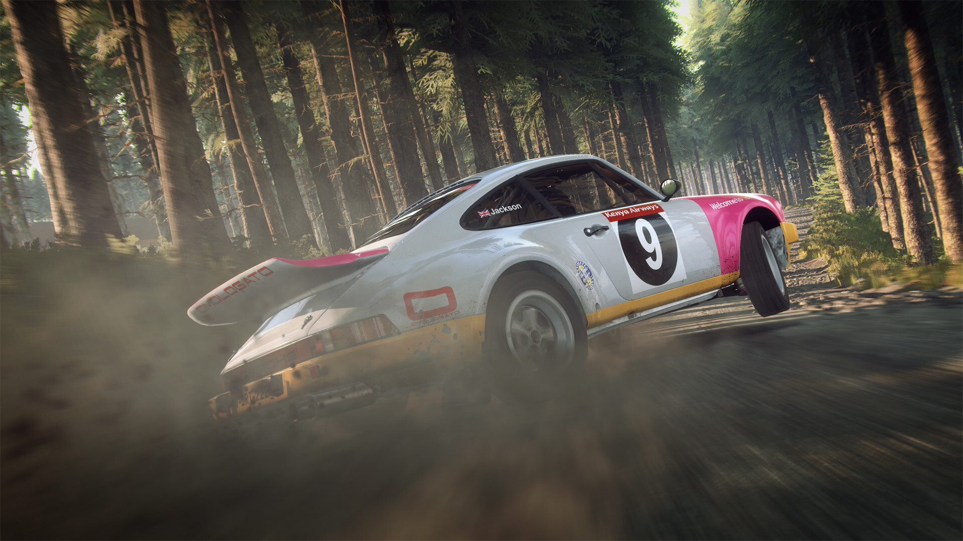 White and pink Porsche 911 rally car sliding on a forest gravel stage in DiRT Rally 2.0