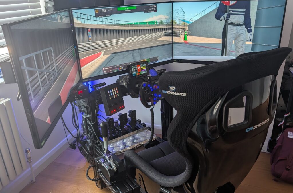 Richard's aluminium profile sim rig with triple screens and a Sim Dynamics seat