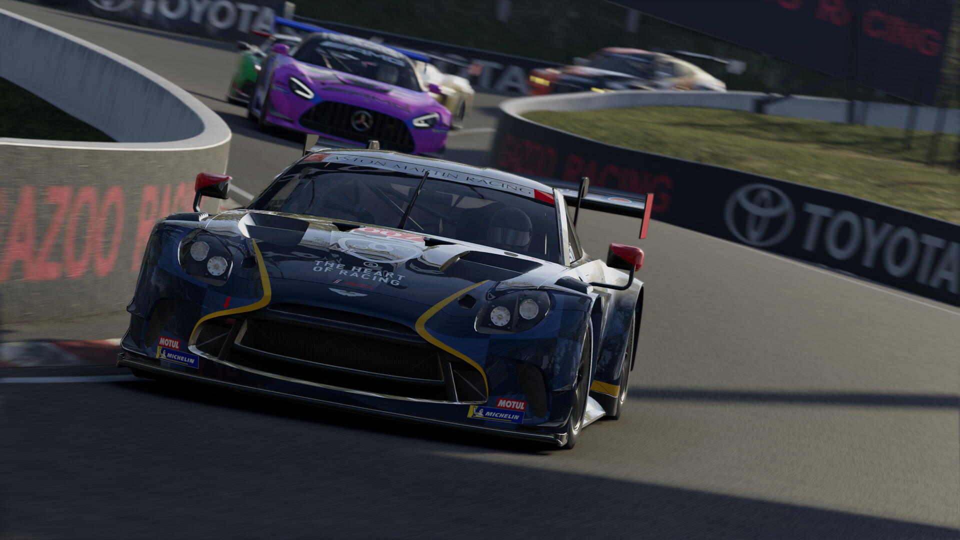 An Aston Martin GT3 car leading a Mercedes-AMG GT3 through a corner in Project Motor Racing