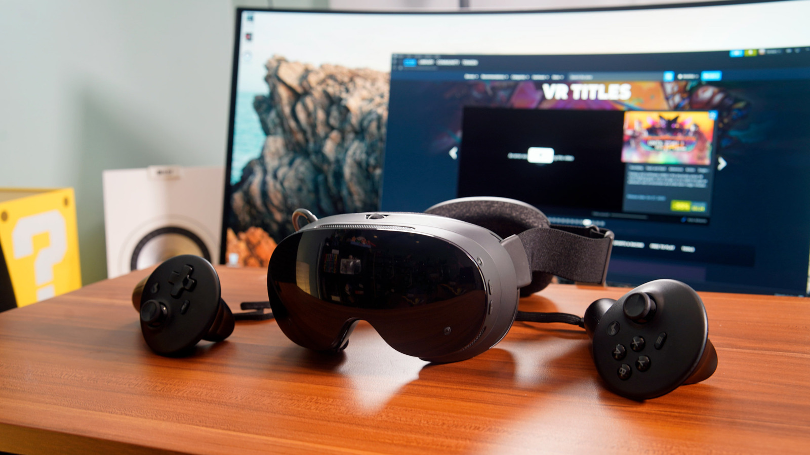 Valve Steam Frame standalone VR headset with its two controllers on a desk