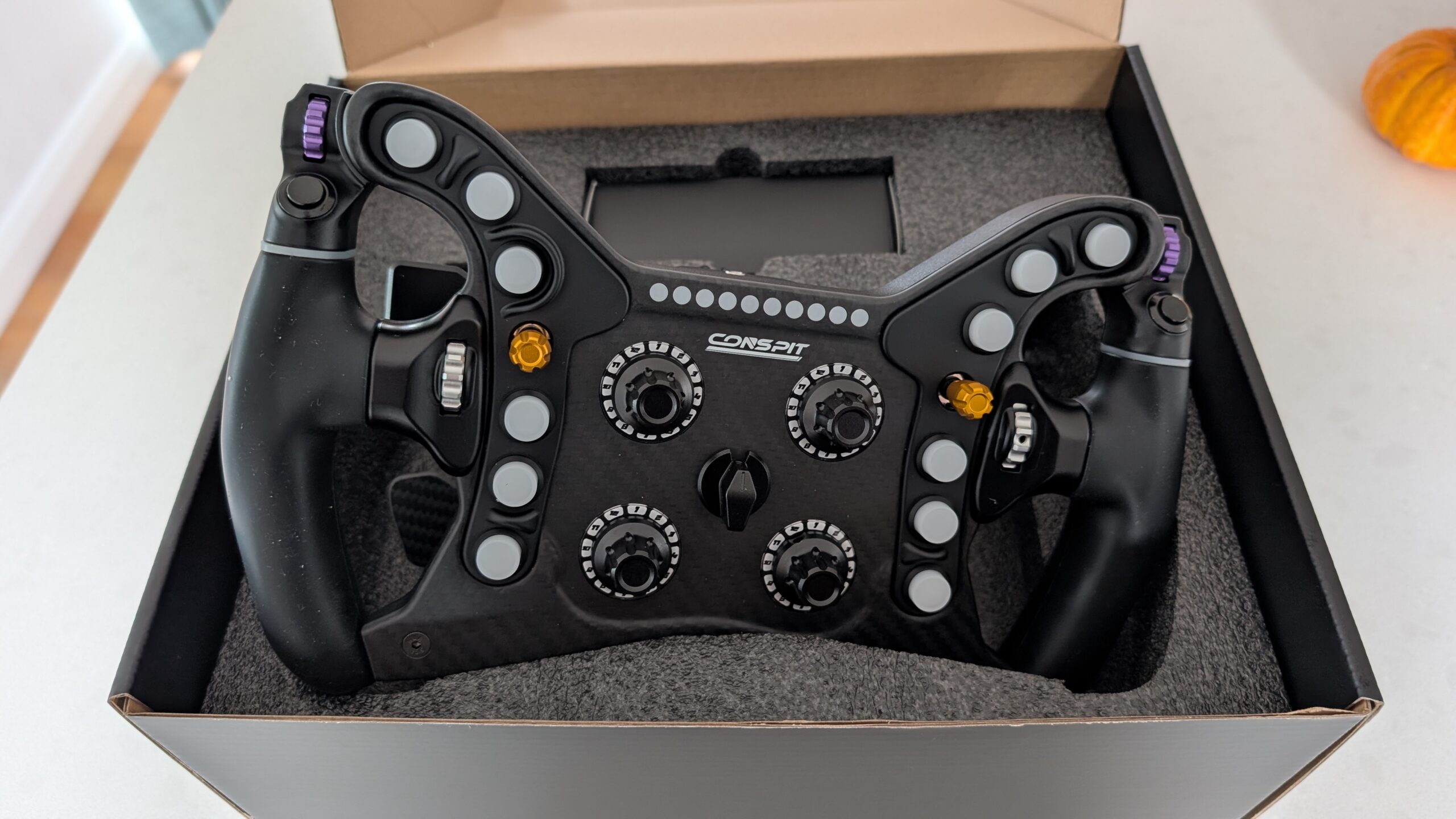 CONSPIT 280 FR in its open box, carbon front plate and purple top encoders visible