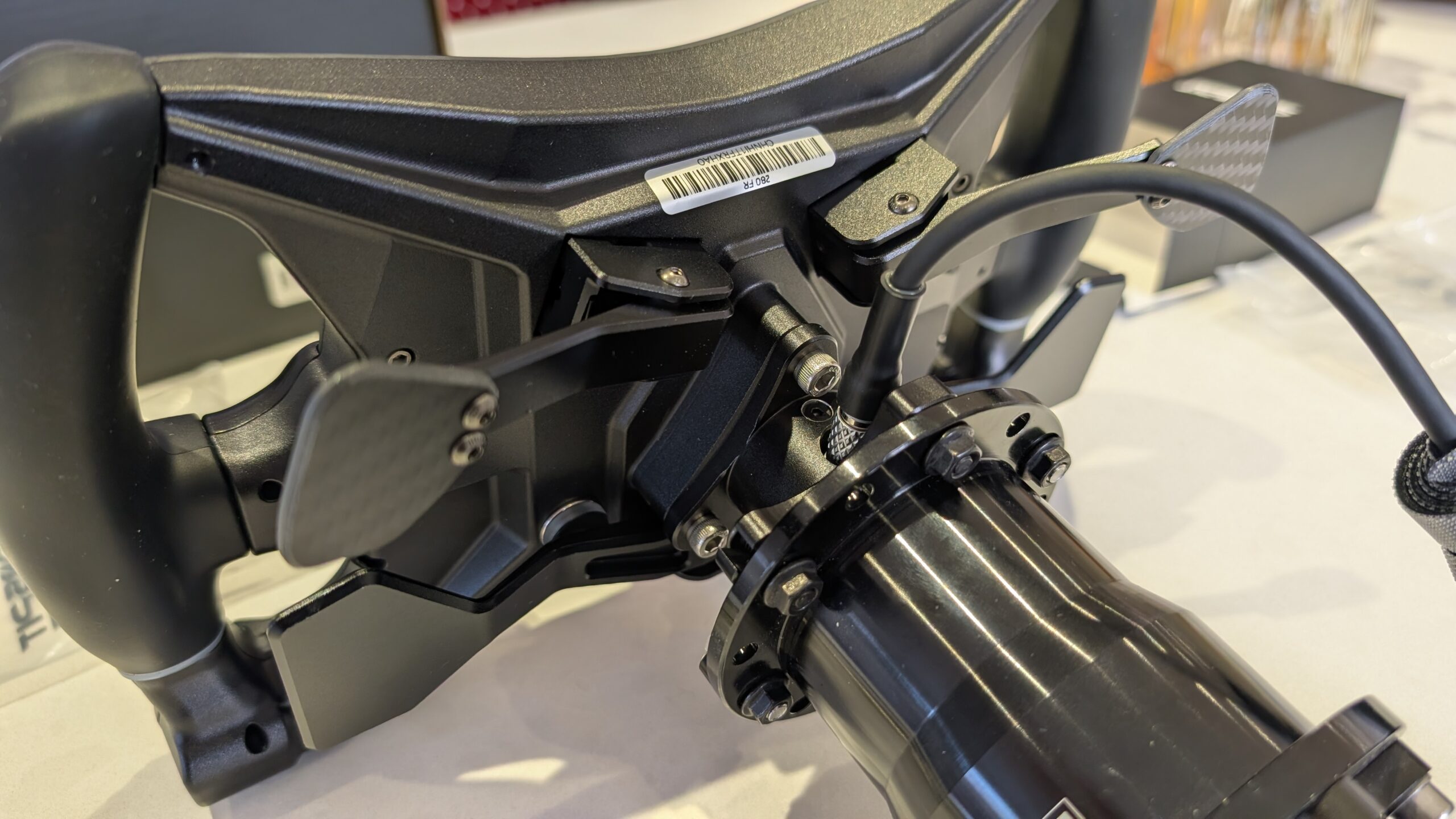 Rear of the CONSPIT 280 FR showing the two carbon clutch paddles on aluminium arms and the hub on the extension