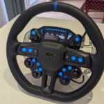 MOZA Ford Mustang GTD sim racing wheel from the front, with its display, blue backlit buttons and four lit rotary encoders