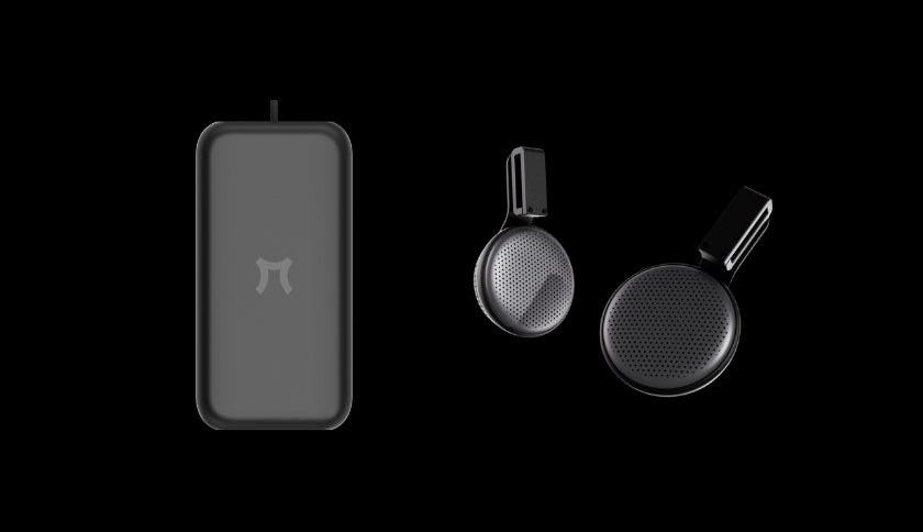 The Pimax Crystal Pro's external battery pack beside two round audio pods